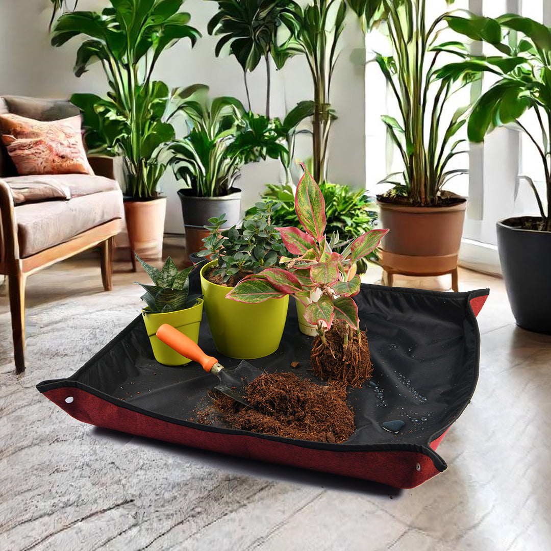 Indoor plant repotting mat with planters and garden soil